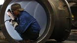 Chinese factory activity shrank in May for the first time in seven months, overshadowing signs that the euro zone's downturn tempered slightly in May, business surveys showed on Thursday.
