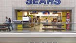 U.S. retailer Sears Holdings  reported a larger-than-expected quarterly loss as cooler weather hurt sales at its department stores and said it was considering a sale of its protection agreement business to shore up liquidity.