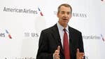 A plan by American Airlines' parent to exit bankruptcy and merge with US Airways Group  is coming under fire from the U.S. Department of Justice over nearly $ million in severance pay earmarked for outgoing boss Tom Horton.