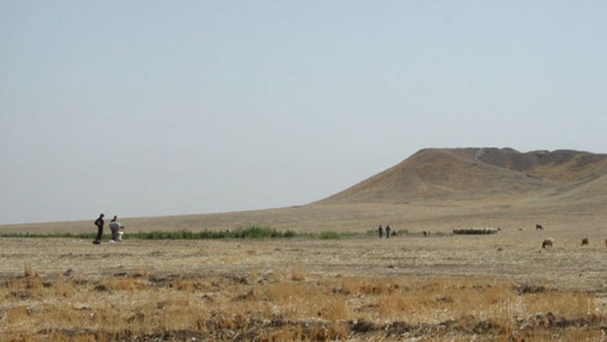 Archaeologists inspect the mound at Tell Brak