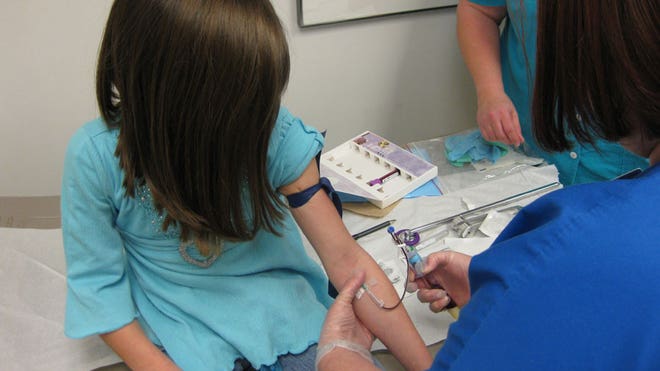 Researchers take a blood sample for analysis