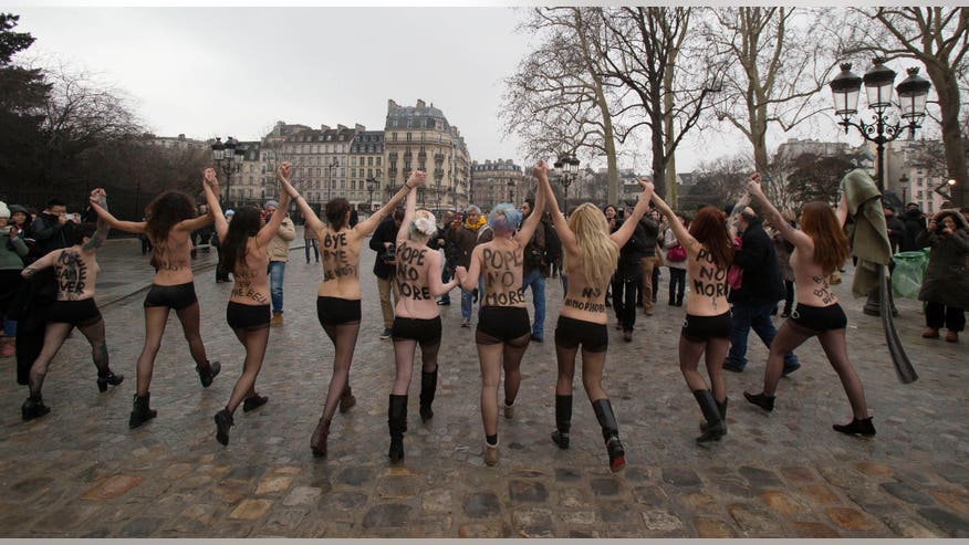 Topless Women Activists Bang Notre Dame Bell In Anti Pope Protest In