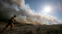  Firefighters had to battle terrain as much as flames as they worked to surround a wildfire entering its third day in harsh hills and mountains north of Los Angeles.