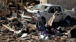  All that is left of Shayne Patterson's three-bedroom home is the tiny area where his wife hunkered down under a mattress to protect their three children when a tornado packing winds of at least  mph slammed through his neighborhood.