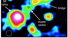 A glowing cosmic structure millions of light-years long represents the aftermath of the impact of two merging galaxy clusters, researchers say.