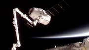 The privately bankrolled Dragon capsule arrived at the International Space Station for a historic docking Friday, captured by astronauts wielding a giant robot arm.