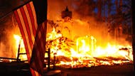 Rain helped firefighters douse Colorado's most destructive wildfire in state history, while a new wind-whipped blaze in California forced evacuations and threatened homes Monday near Yosemite National Park.