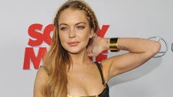 >Lohan appeared to blame her tardiness on a dress mix-up and smiled when fans chanted her name.