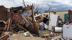 Does the idea of the existence of a loving God get swept away in the wake of tornadoes or hurricanes like a tin building or mobile home?