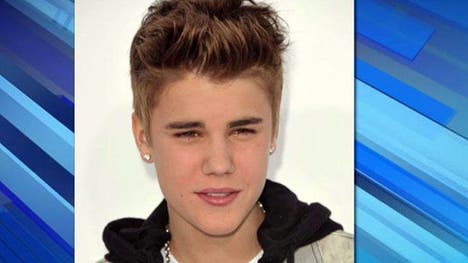 He's not yet a fugitive from justice, but Justin Bieber has taken to Twitter to let his fans know he's off to Europe as Los Angeles detectives seek to question the pop superstar about an alleged attack Sunday against a photographer.