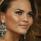 Chrissy Teigen has wild time on news set