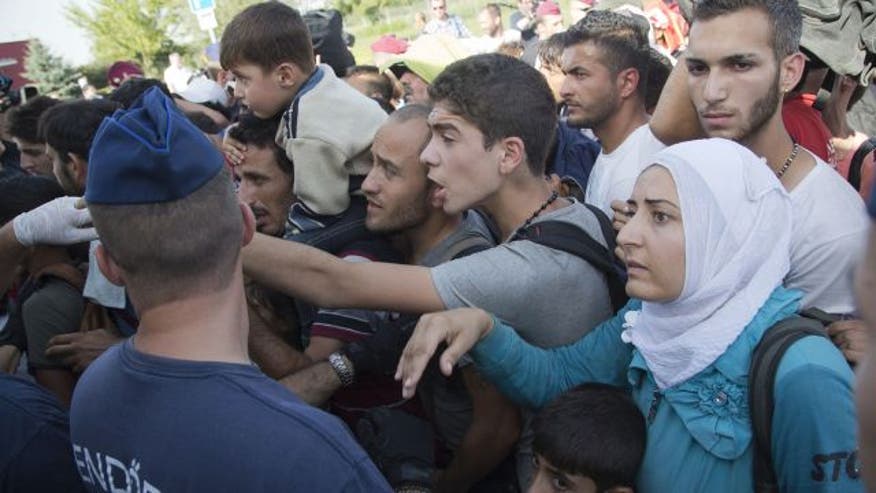Croatia closes border to refugees after nearly 14,000 enter in 2 days - Video shows refugees being fed 'like animals' - Refugee crisis: 'We just want a new life'