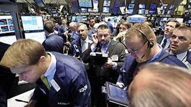 Friday: Traders on Wall Street gather at the post that handles Citigroup (AP Photo).