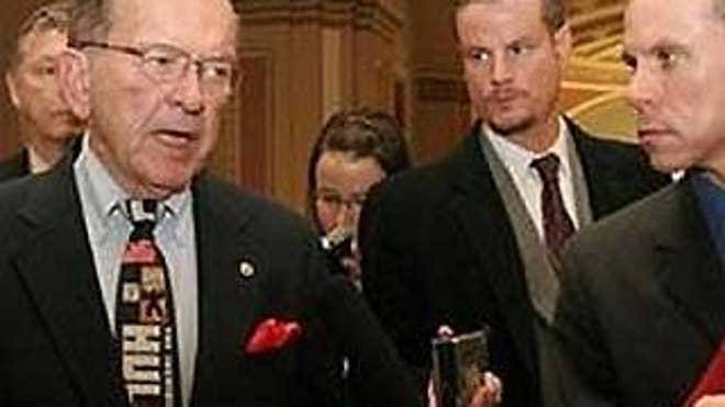Alaska Sen. Ted Stevens, left, wears his trademark Incredible Hulk tie during a scrum with reporters in 2005. FOX News' Chad Pergram stands at right (Chad Pergram).