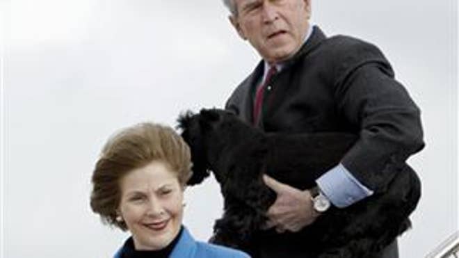 Dec. 26: President and First Lady Bush head to their home in Crawford, Texas (AP Photo).