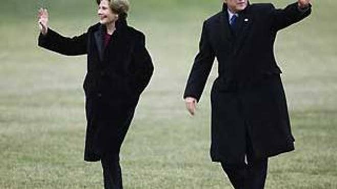 Jan. 18: President and Mrs. Bush walk across the White House lawn from Marine One for the last time (AP Photo).