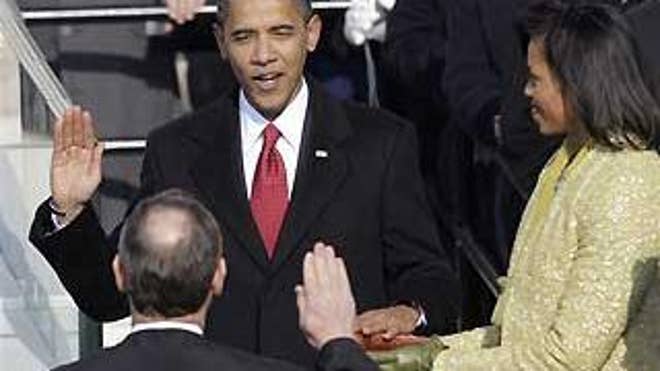 Jan. 20: Barack Obama takes the oath of office from Chief Justice John Roberts as Michelle Obama stands by her husband's side (AP Photo).