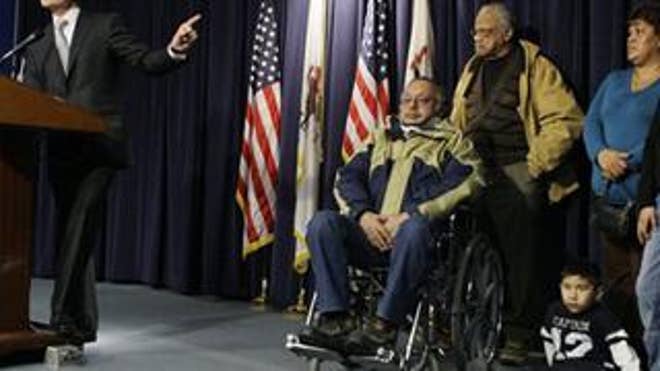 Blagojevich responds to impeachment with his supporters looking on.