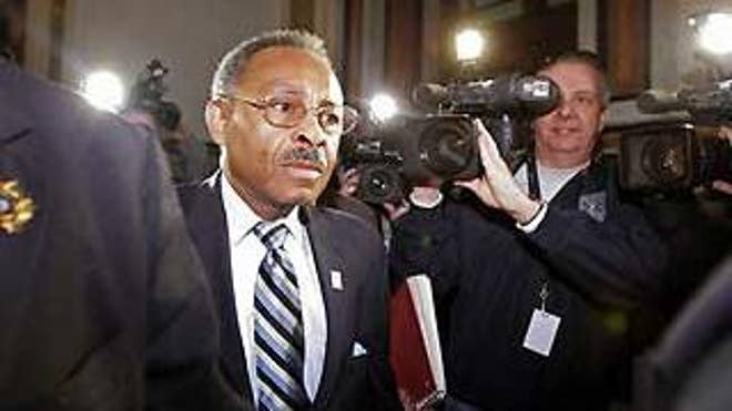 Surrounded by cameras, U.S. Senate appointee Roland Burris enters the Illinois State Capitol to testify before the Illinois House Impeachment Committee Thursday, Jan. 8, 2009, in Springfield, Ill.