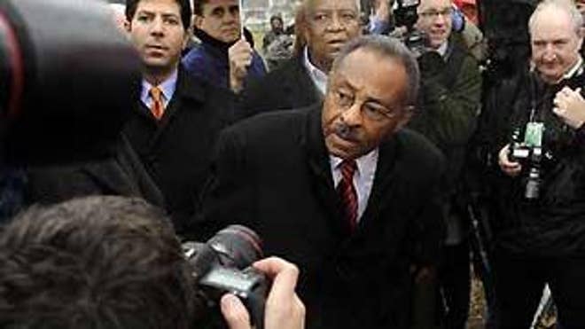 Surrounded by press, police, and staff, Illinois U.S. Senate Appointee Roland Burris looks for his car as he leaves Capitol Hill in Washington, Tuesday, Jan. 6, 2009. (AP Photo/Susan Walsh)