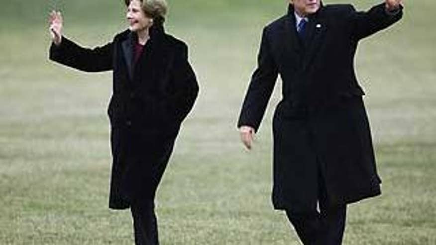 Jan. 18: President and Mrs. Bush walk across the White House lawn from Marine One for the last time (AP Photo).
