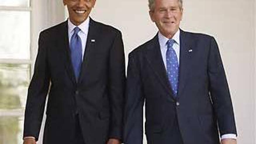 Monday: President-elect Obama and President Bush walk through the Colonnade in the West Wing of the White House (AP Photo).