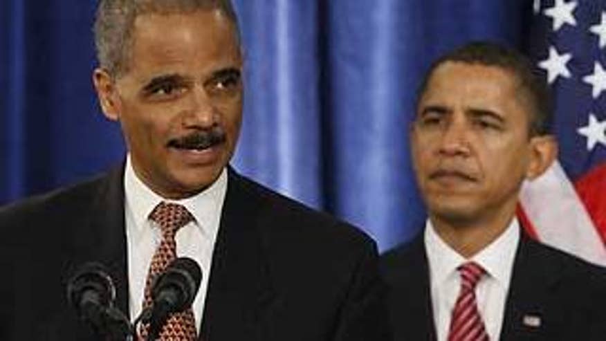 In this Dec. 1, 2008, file photo, Attorney General-designate Eric Holder speaks during a news conference with President-elect Barack Obama, right, in Chicago. (AP Photo/Charles Dharapak, File)