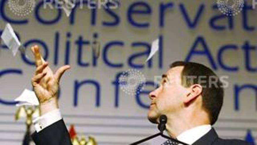 Mike Huckabee tears up a federal tax form