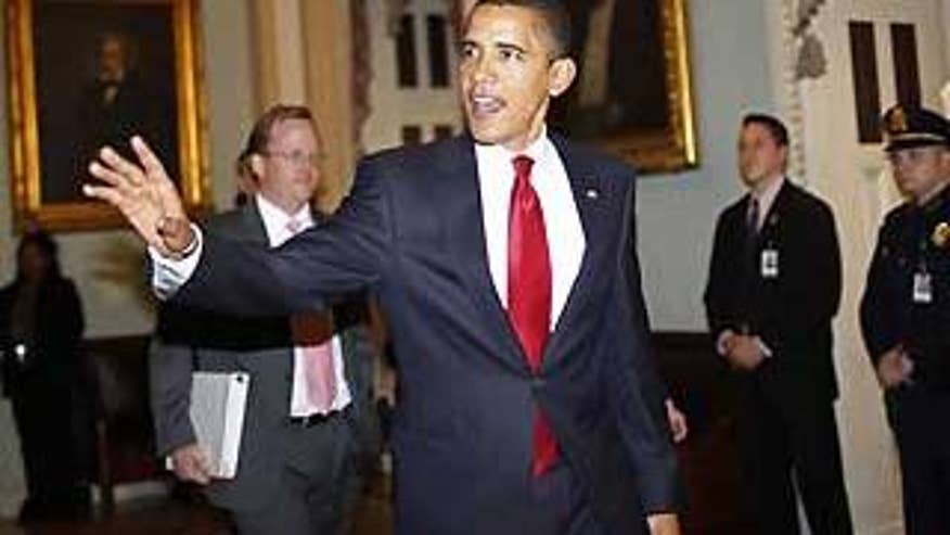 Jan. 27: President Barack Obama, followed by spokesman Robert Gibbs, before making a statement after meeting with lawmakers on Capitol Hill. (AP Photo)