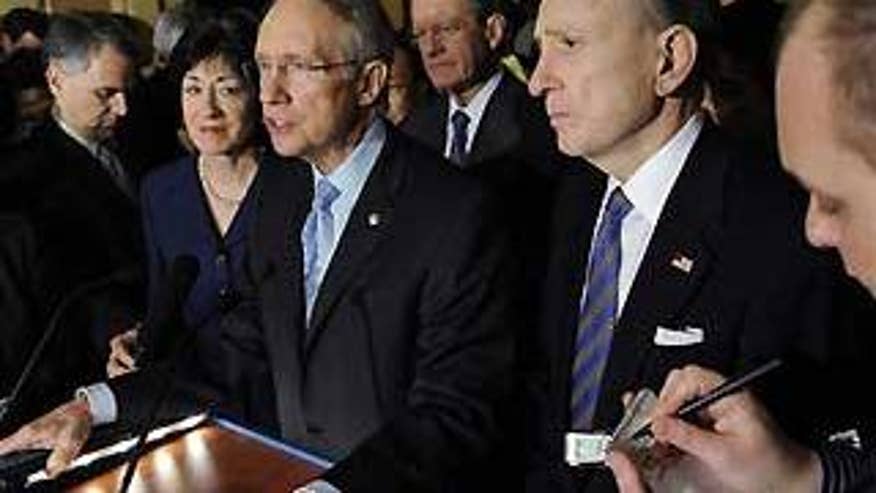 Senate Majority Leader Harry Reid, and other senators, speak to reporters on Capitol Hill in Washington Wednesday. (AP Photo)