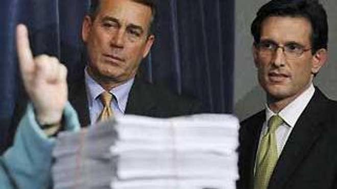 House Minority Leader John Boehner and Minority Whip Eric Cantor stand by a copy of the stimulus bill in February in Washington. (Reuters Photo)
