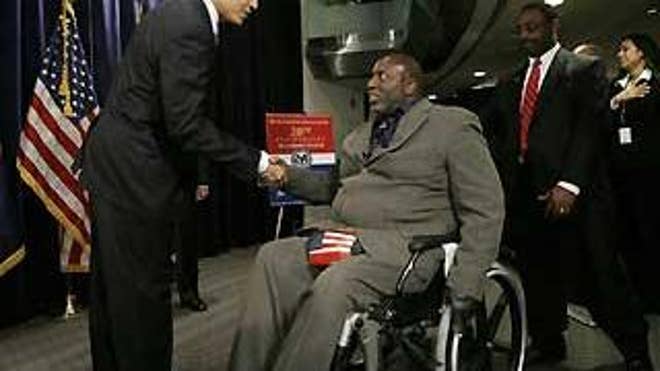 March 16: President Obama greets veteran Mahdee Abdul Sabir, who led the pledge of allegiance during Obama's visit to the Department of Veterans Affairs (Reuters).