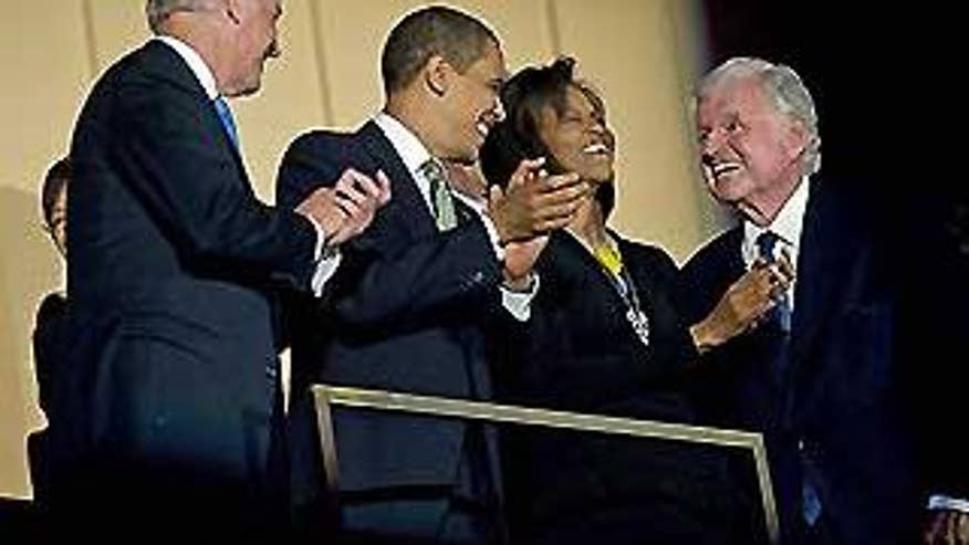 March 8, 2009: Sen. Edward Kennedy, D-Mass., right, laughs with first lady Michelle Obama, President Barack Obama, and Vice-President Joe Biden during a musical birthday salute to Kennedy at The Kennedy Center in Washington. (AP)