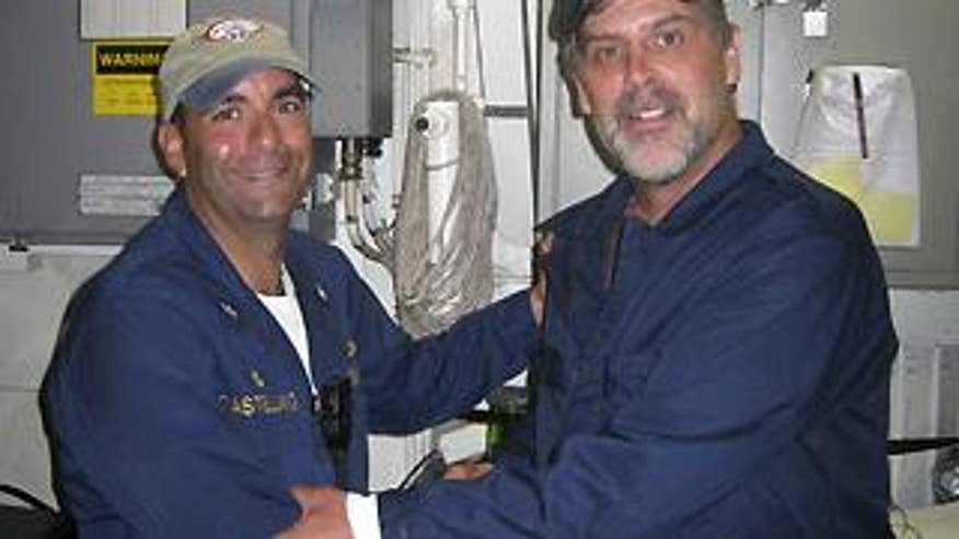 April 12, 2009: In this photo released by the U.S. Navy, Maersk-Alabama Capt. Richard Phillips, right, shakes hands with Lt. Cmdr. David Fowler, executive officer of USS Bainbridge after being rescued by U.S Naval Forces off the coast of Somalia.