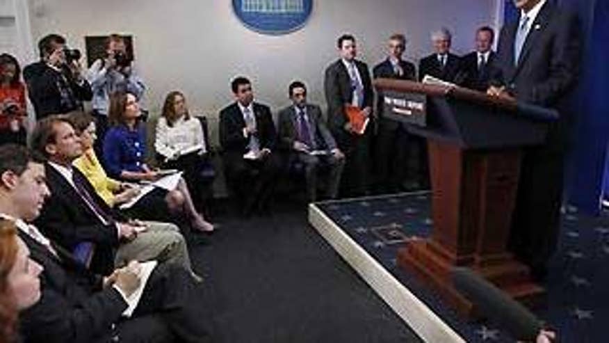 President Obama makes a surprise appearance during the daily press briefing at the White House Friday. (AP Photo)