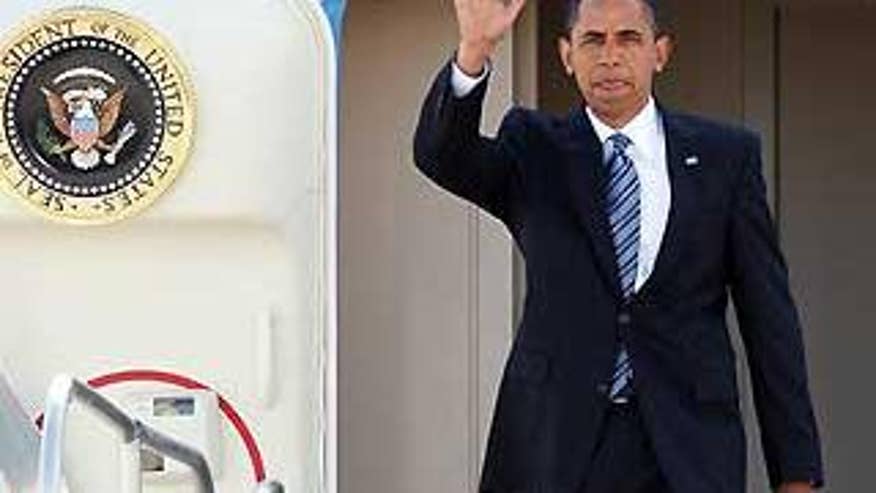 President Obama waves as he exits Air Force One upon arrival in Las Vegas Tuesday. (AP Photo)