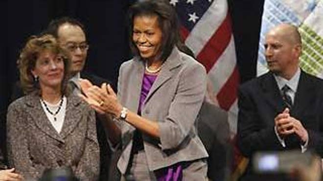 First Lady Michelle Obama applauds before making remarks at the Department of Housing and Urban Development in Washington on Wednesday. (AP Photo)