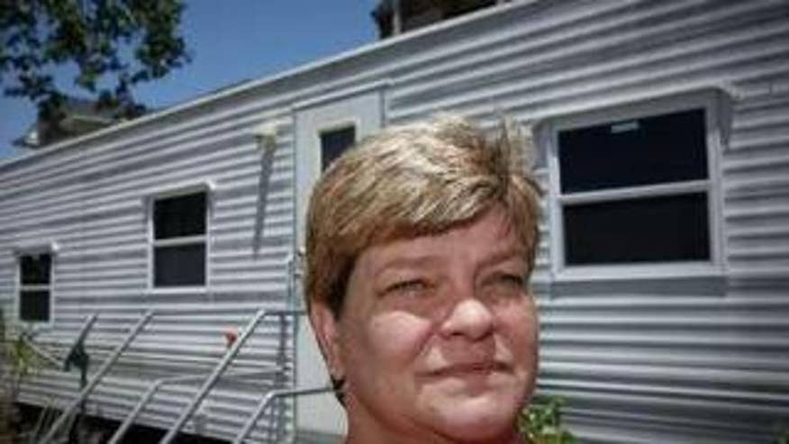 Katrina Survivor Poses Outside her FEMA Trailer