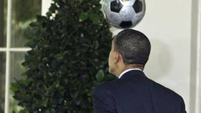 President Obama heads a soccer ball as he walks to The Oval Office
