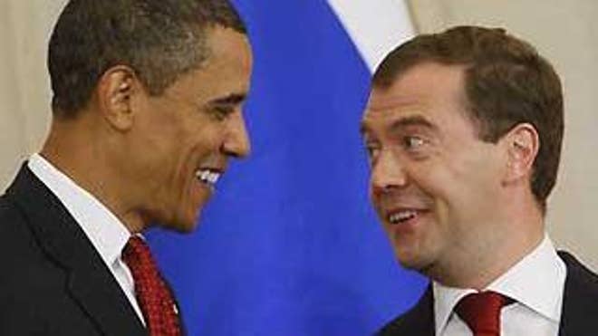July 6, 2009: President Obama and President Medvedev talk before they signed a preliminary agreement to reduce the world's two largest nuclear stockpiles (AP Photo).