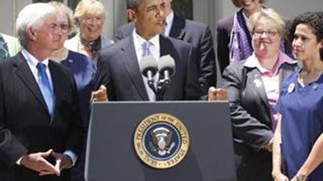 President Obama talks about health care reform in the Rose Garden Wednesday, flanked by nurses and members of Congress. (AP Photo)
