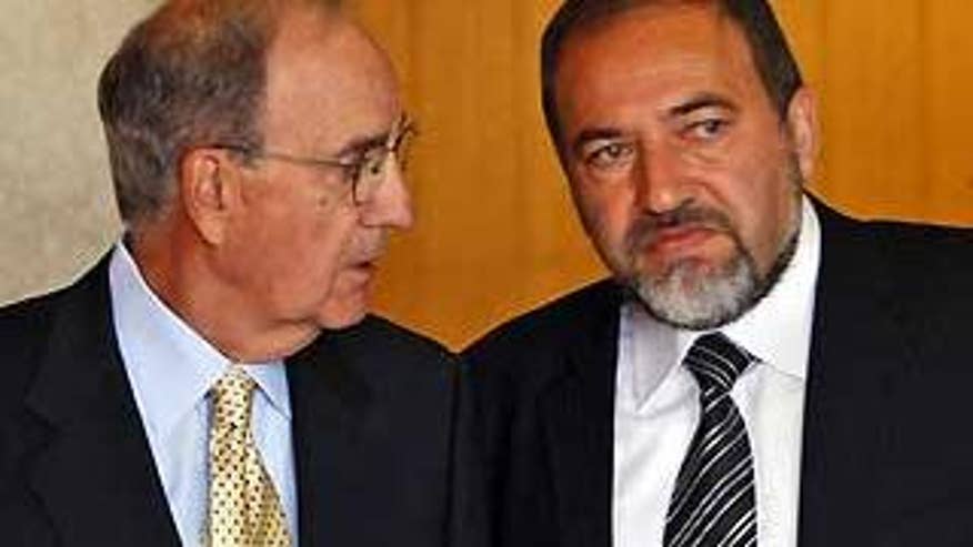 April 16: U.S. Middle East envoy George Mitchell, left, talks to Israeli Foreign Minister Avigdor Lieberman after their meeting in Jerusalem. (AP photo)