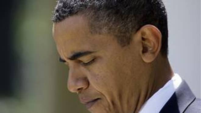 President Barack Obama pauses