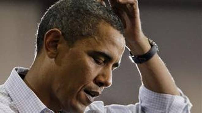 Aug. 14, 2009: President Obama scratches his head as he speaks about health care at a town hall meeting in a hangar at Gallatin Airfield in Belgrade, Mont. ( AP)