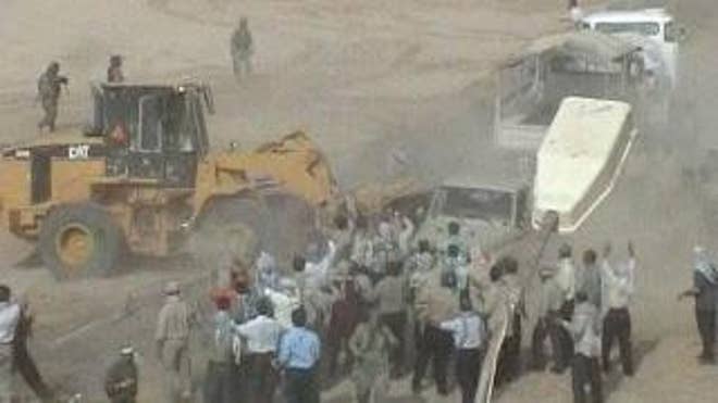 Iraqi forces are shown here raiding Camp Ashraf in late July. (Courtesy of the National Council of Resistance of Iran)