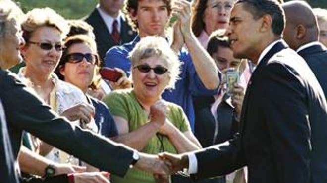 President Obama greets visitors at the White House
