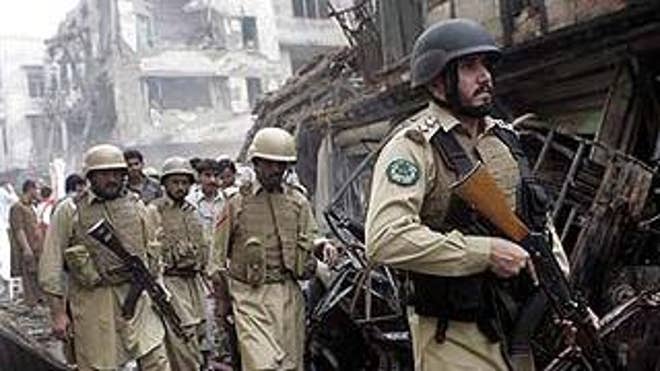 Oct. 28: Troops of Pakistani para-military force arrive at the site of a deadly explosion in Peshawar, Pakistan.  (AP)