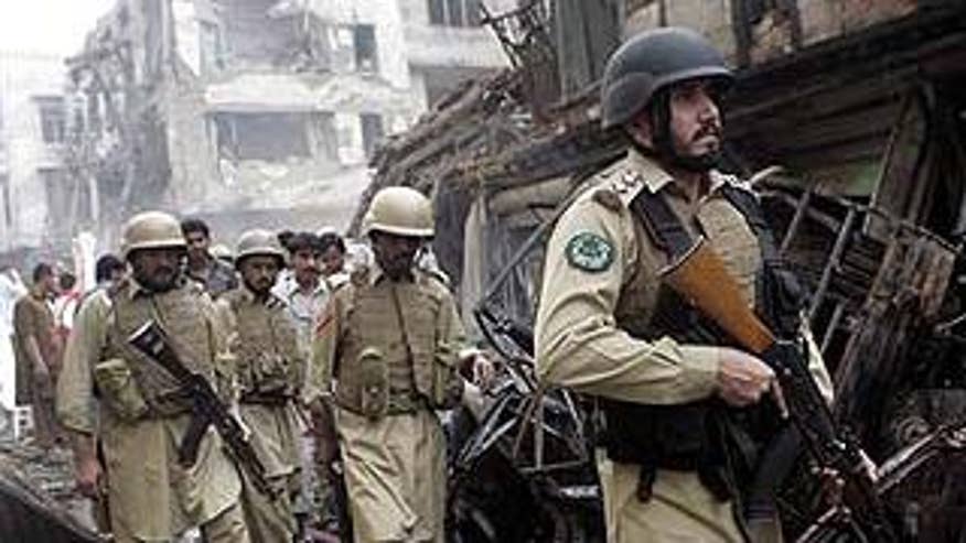 Oct. 28: Troops of Pakistani para-military force arrive at the site of a deadly explosion in Peshawar, Pakistan. (AP)