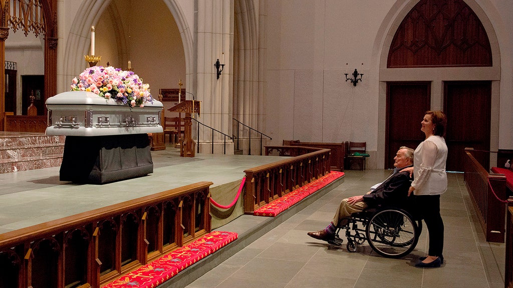 Powerful photo shows George H.W. Bush looking at wife's casket