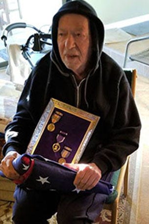 Rapper returns Purple Heart